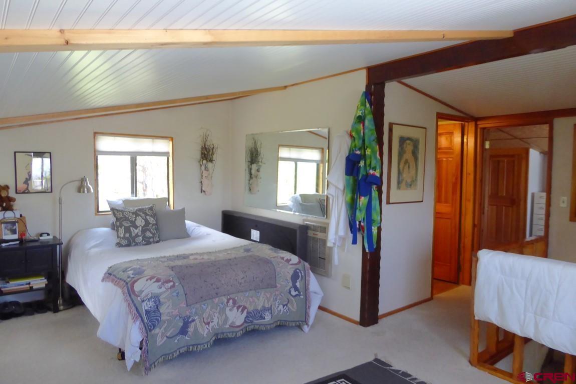 21550 2300th Road Cedaredge, CO 81413 - Photo 18 of 35 a bedroom with a large bed and a window