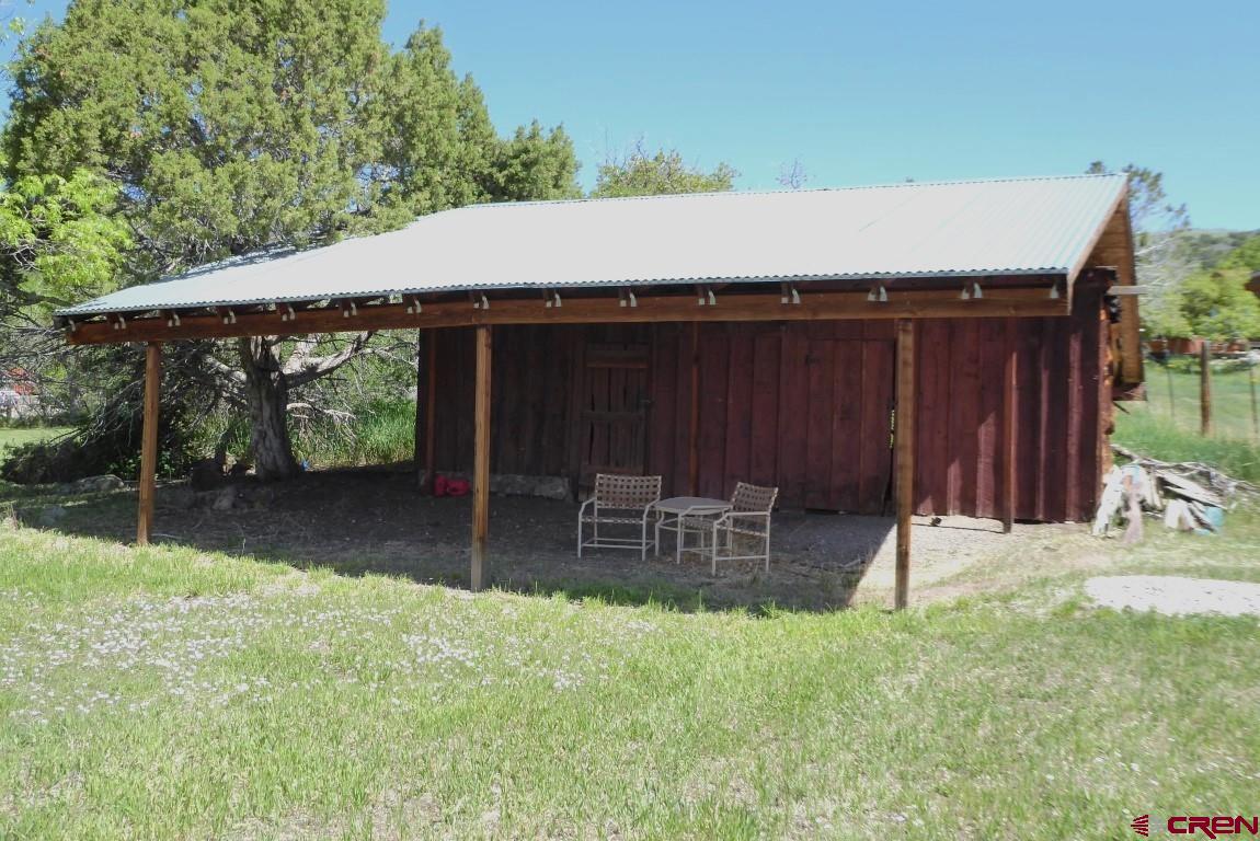 21550 2300th Road Cedaredge, CO 81413 - Photo 27 of 35 a backyard of a house with table and chairs