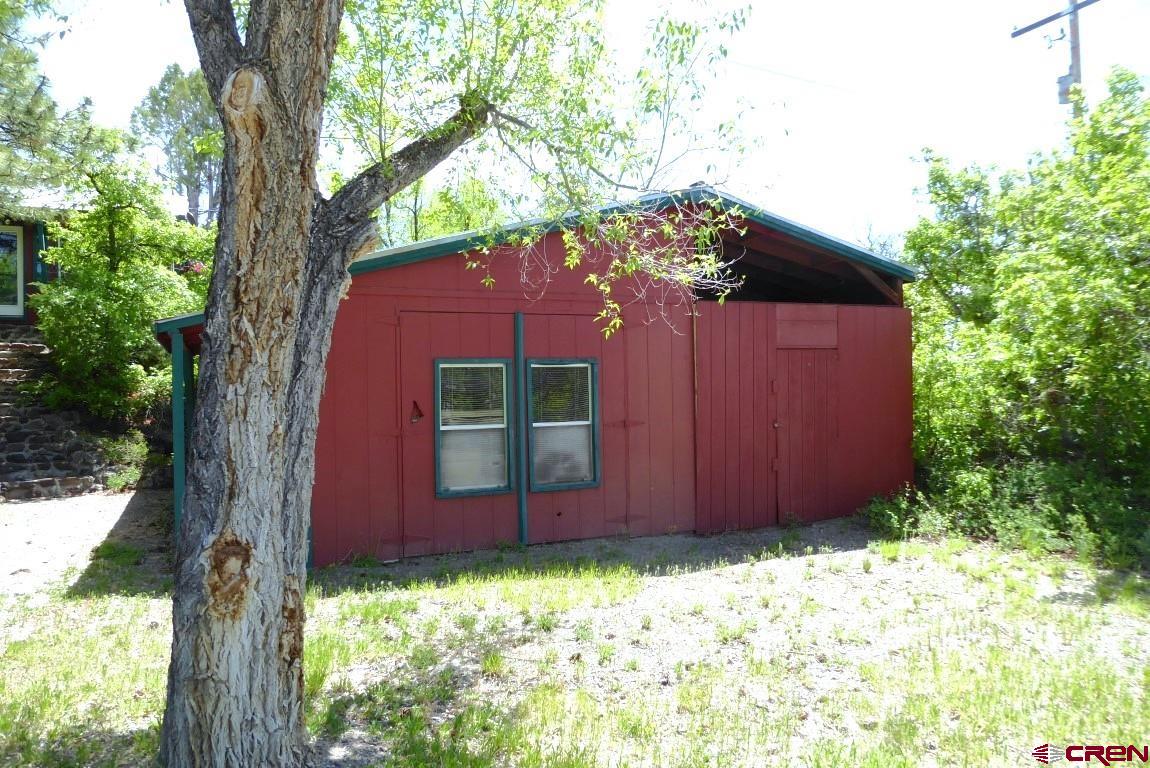21550 2300th Road Cedaredge, CO 81413 - Photo 28 of 35 a house with trees in front of it