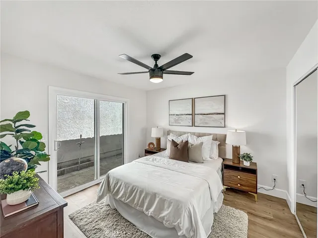 a bedroom with a bed and a potted plant