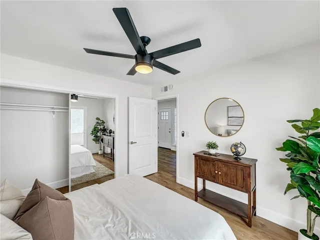 a bedroom with bed and a chandelier