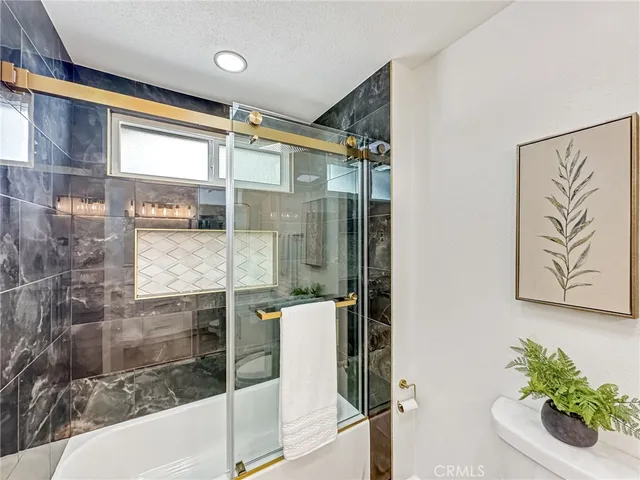 a bathroom with a bathtub and a shower