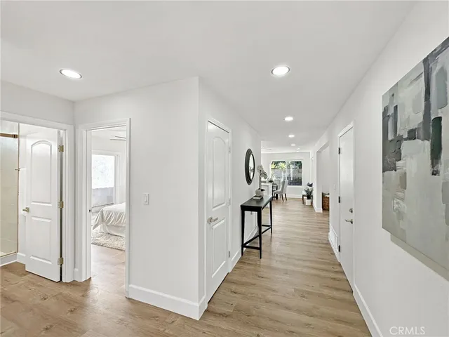 a view of a hallway with wooden floor windows and livingroom view