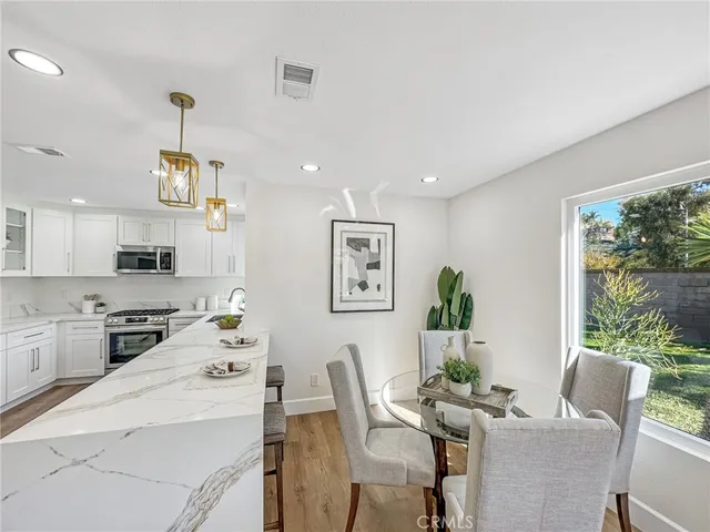 a dining room with furniture and window