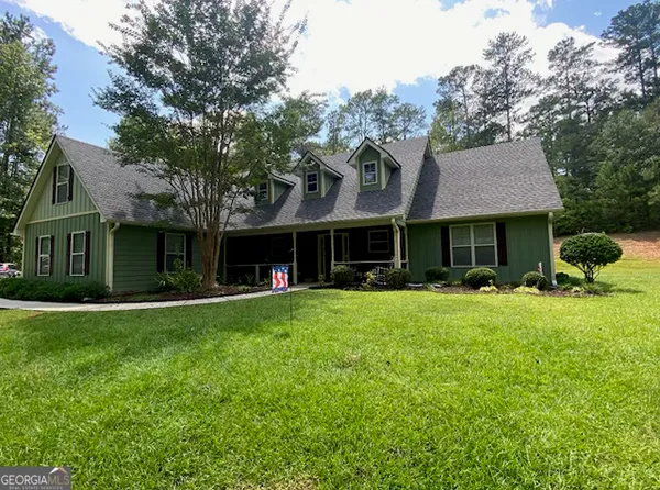a front view of a house with a garden and porch