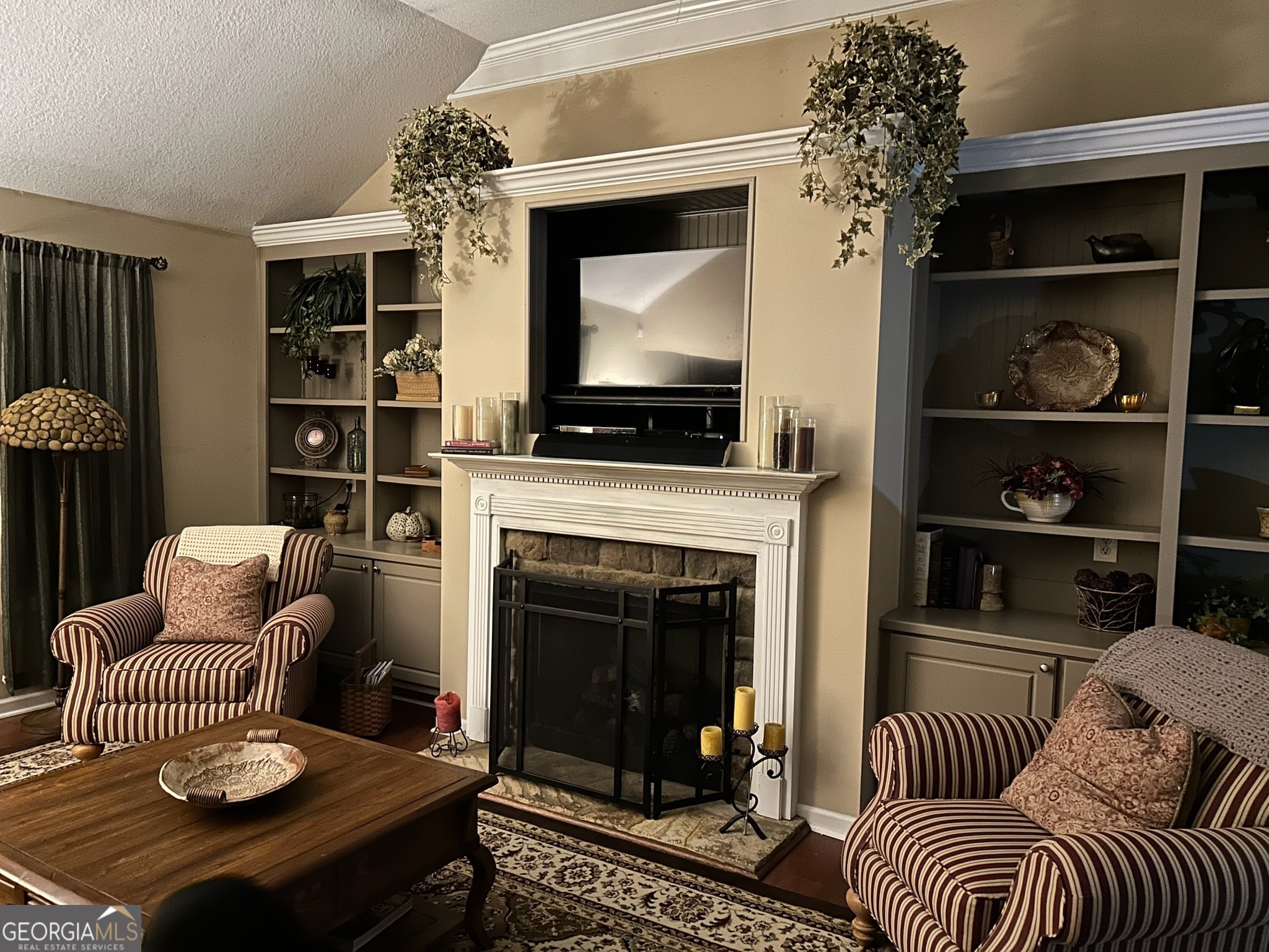 950 John Lovelace Road LaGrange, GA 30241 - Photo 14 of 47 a living room with furniture a flat screen tv and a fireplace