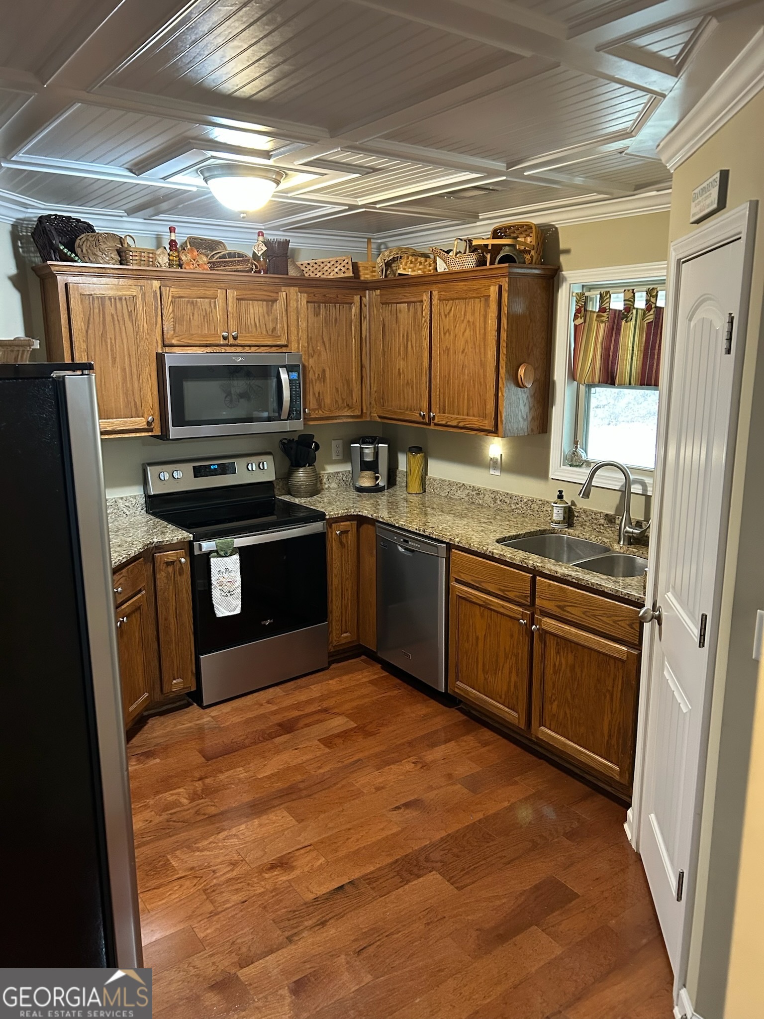 950 John Lovelace Road LaGrange, GA 30241 - Photo 17 of 47 a kitchen with stainless steel appliances granite countertop a stove top oven a sink dishwasher a refrigerator and a microwave