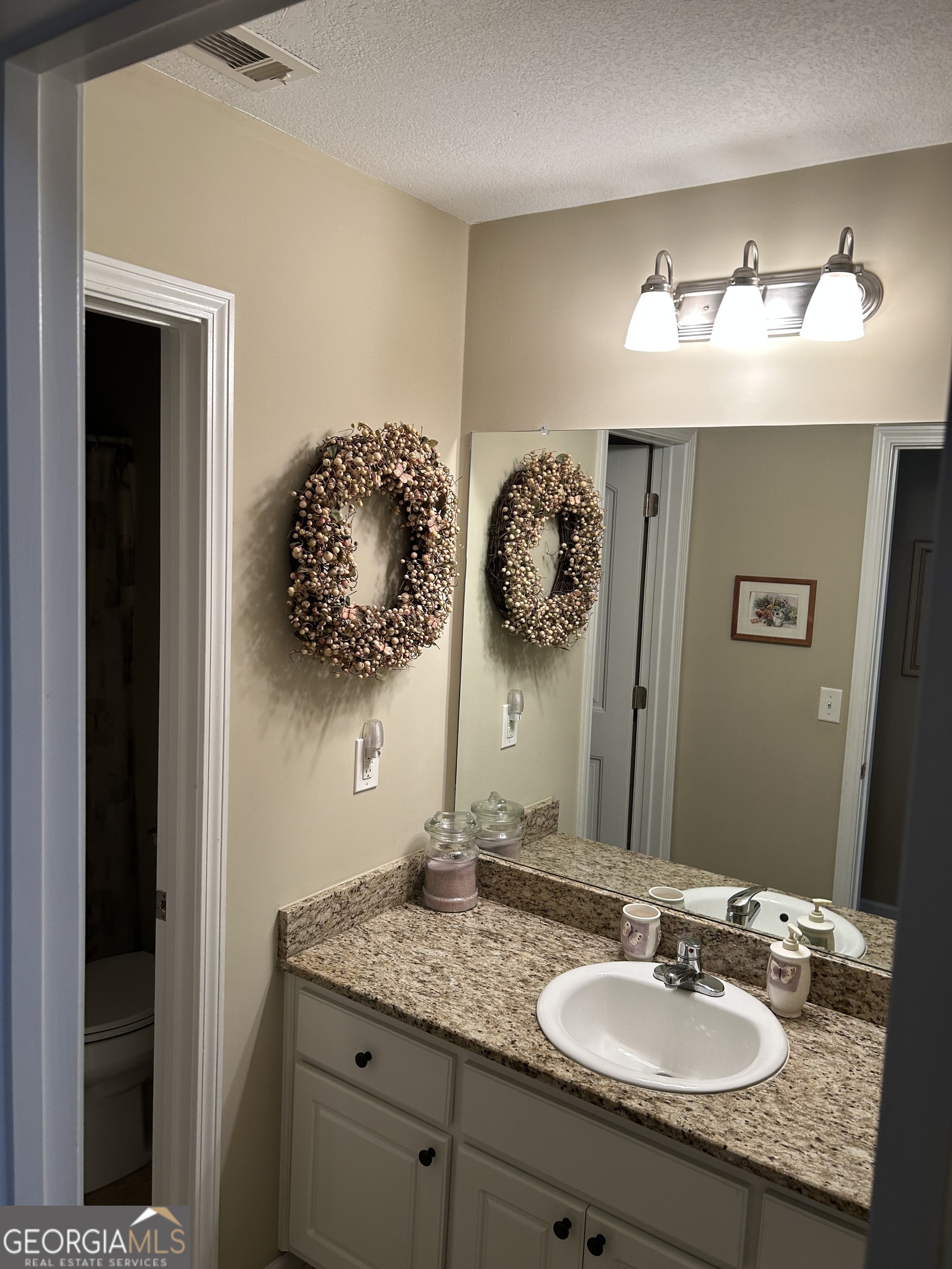 950 John Lovelace Road LaGrange, GA 30241 - Photo 34 of 47 a bathroom with a granite countertop sink and a mirror