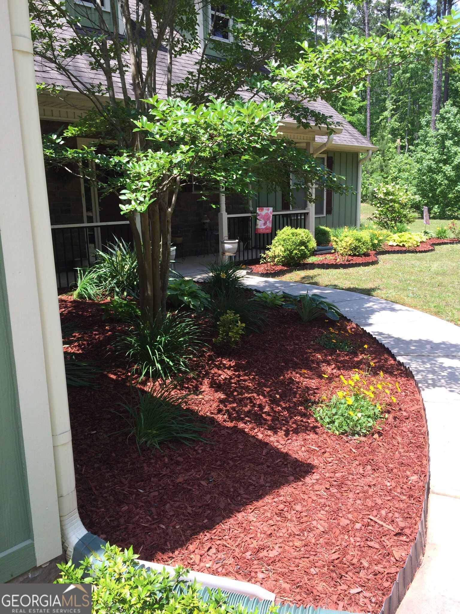 950 John Lovelace Road LaGrange, GA 30241 - Photo 8 of 47 a front view of a house with a yard and a garden
