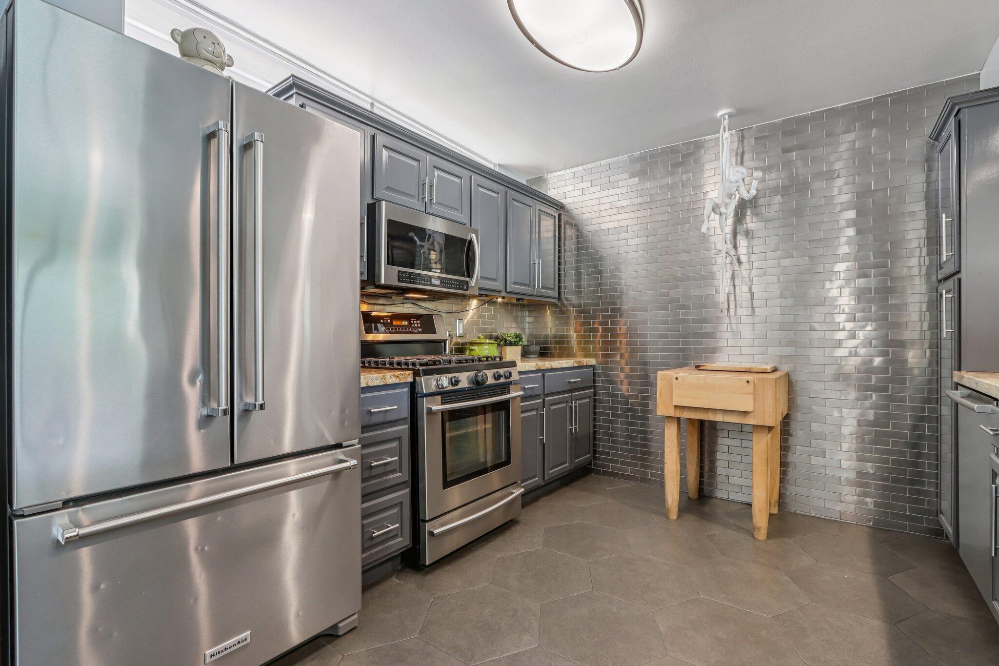 1815 West Nicola Road Palm Springs, CA 92262 - Photo 12 of 30 a kitchen with stainless steel appliances a refrigerator stove and sink