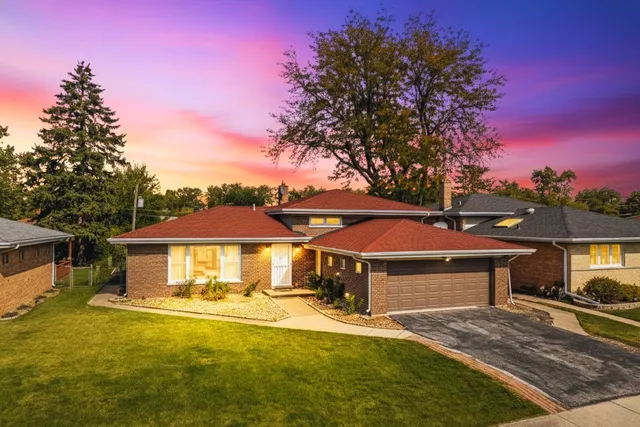 a front view of a house with yard swimming pool and outdoor seating
