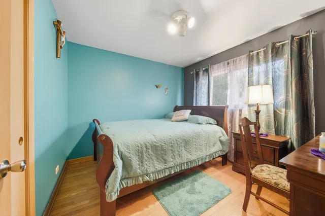 a bedroom with a bed window and couch