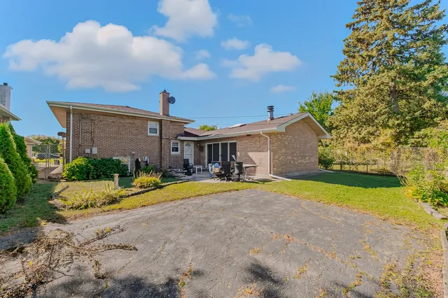 a view of a house with pool and a yard
