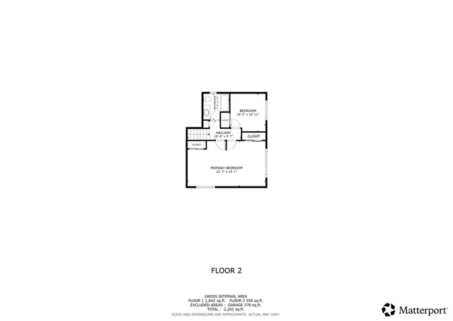 a picture of a room with a white wall and bed