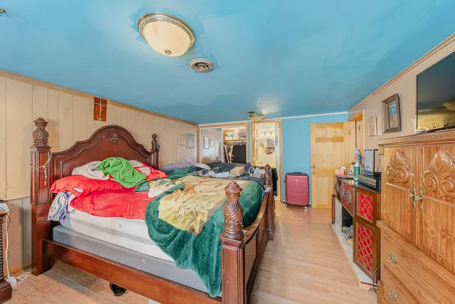 a bedroom with bed and a window