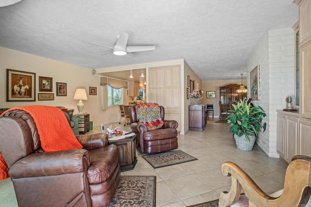 10951 Rim Road Escondido, CA 92026 - Photo 18 of 55 a living room with furniture potted plant and a chandelier