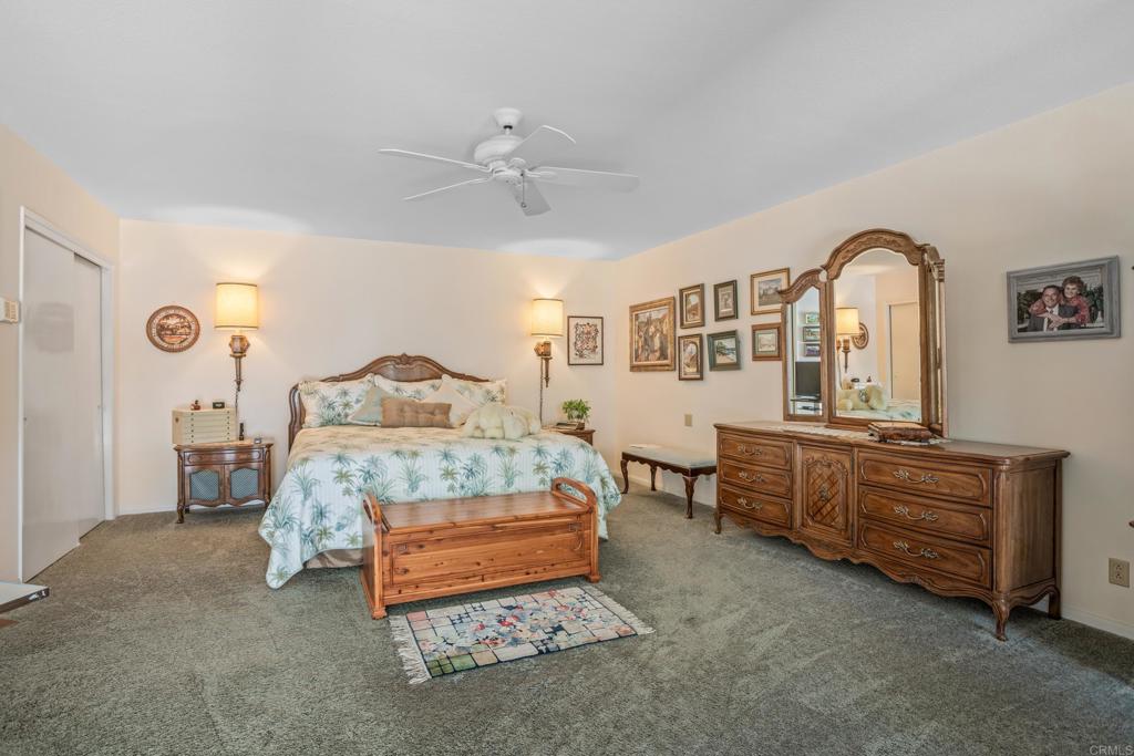 10951 Rim Road Escondido, CA 92026 - Photo 26 of 55 a bedroom with a bed and a chandelier