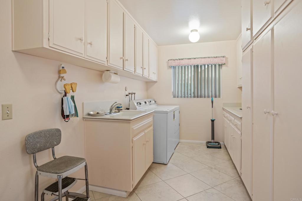 10951 Rim Road Escondido, CA 92026 - Photo 33 of 55 a utility room with cabinets washer and dryer