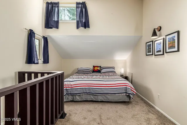 a bedroom with bed and a window