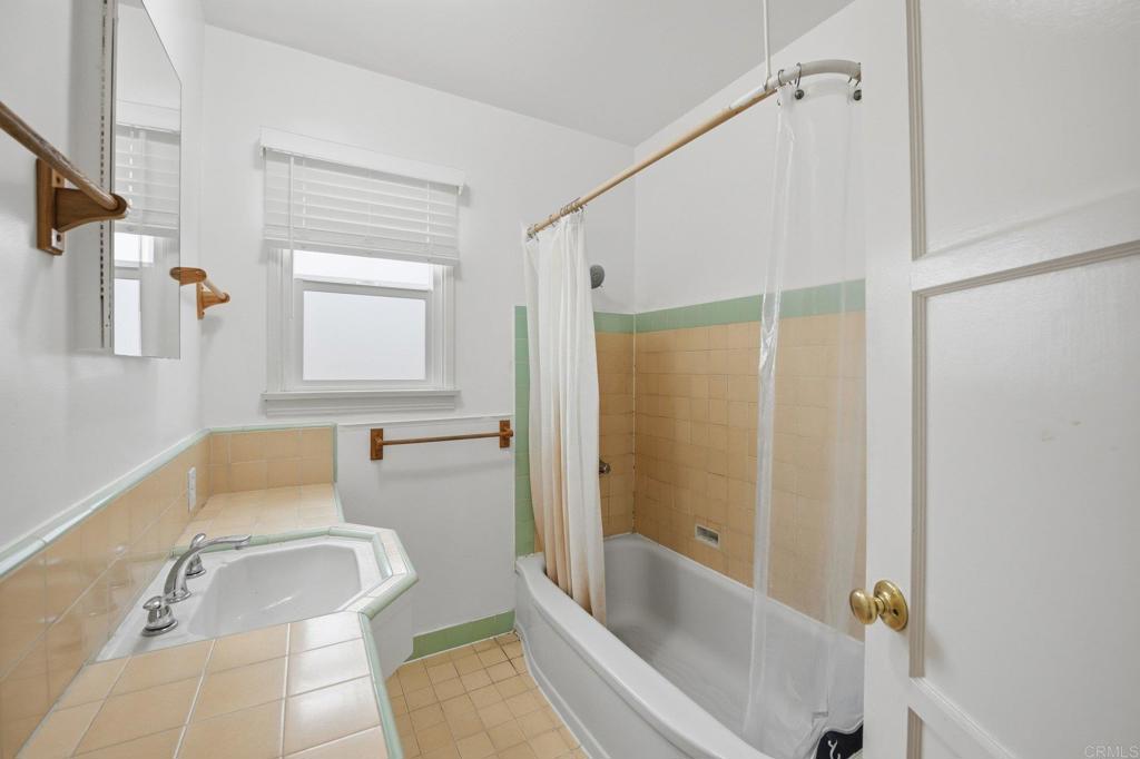 6974 Capistrano Way Riverside, CA 92504 - Photo 12 of 24 a bathroom with a tub shower and sink