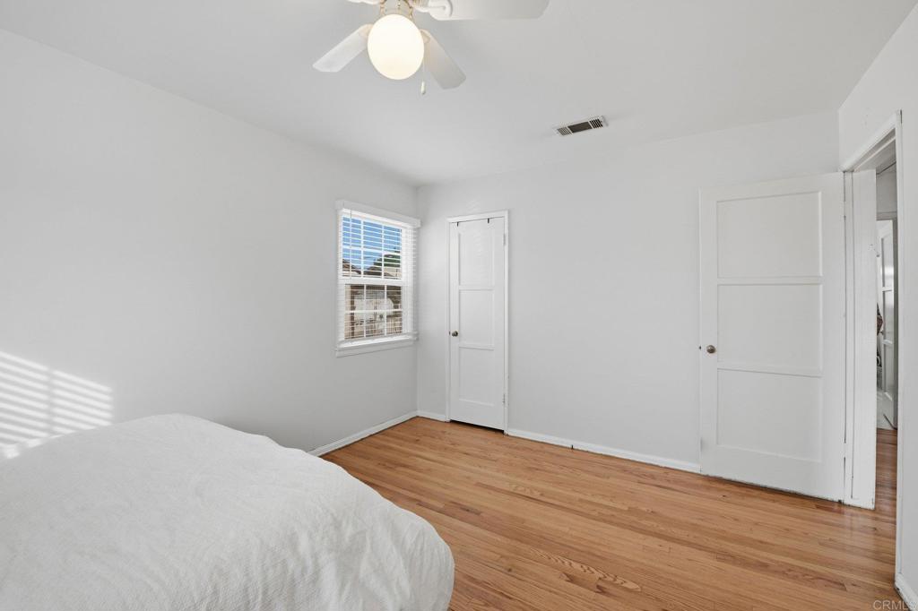 6974 Capistrano Way Riverside, CA 92504 - Photo 14 of 24 a bedroom with a bed and wooden floor