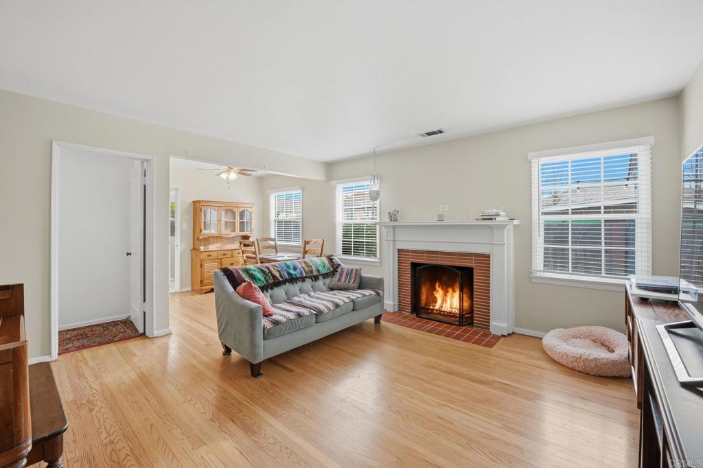 6974 Capistrano Way Riverside, CA 92504 - Photo 3 of 24 a living room with furniture and a fireplace
