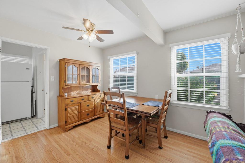 6974 Capistrano Way Riverside, CA 92504 - Photo 6 of 24 a dining room with a wooden table and chairs