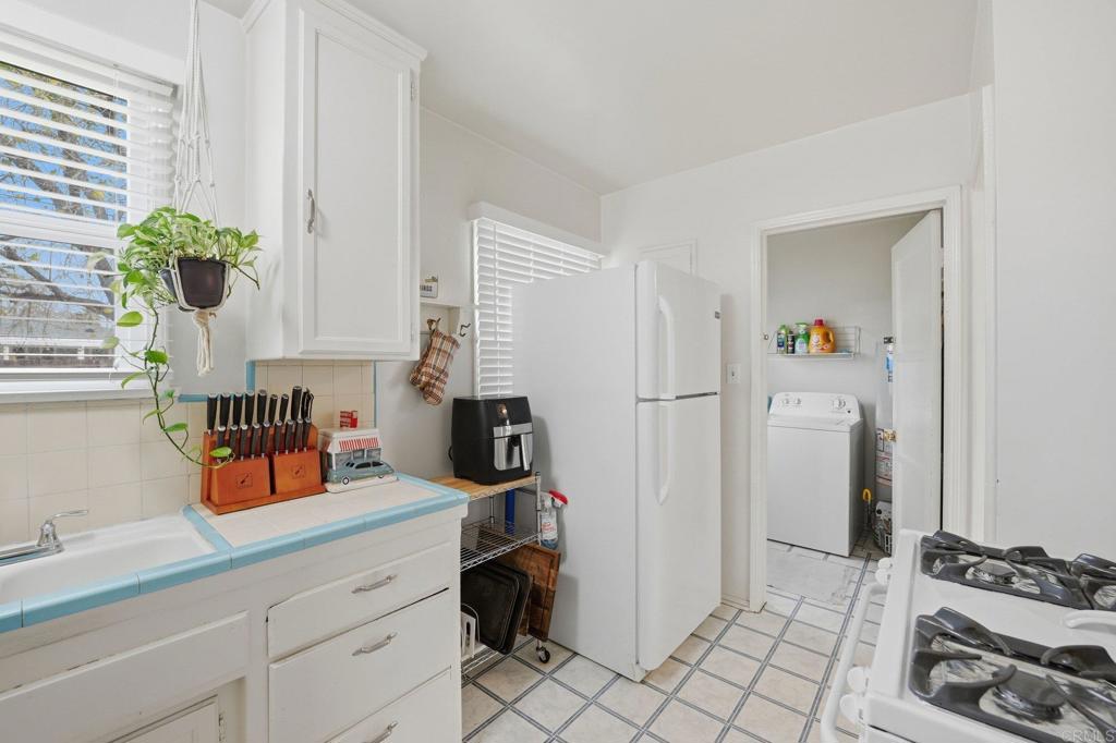 6974 Capistrano Way Riverside, CA 92504 - Photo 10 of 24 a kitchen with stainless steel appliances kitchen island granite countertop a refrigerator and a sink