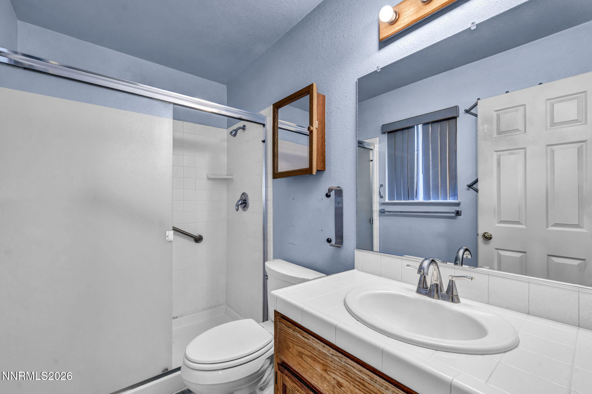 692 Lassen Way Gardnerville, NV 89460 - Photo 18 of 34 a bathroom with a sink toilet and shower