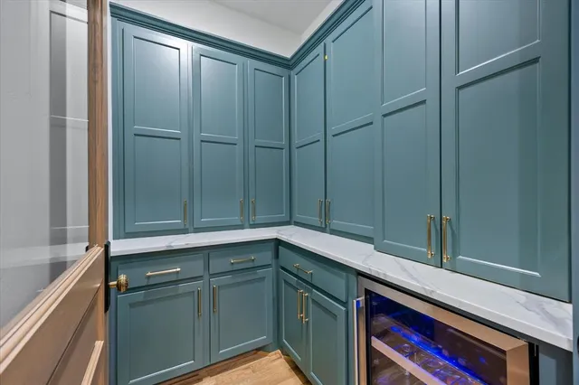 a spacious bedroom with a bed a couch and potted plant on the dresser