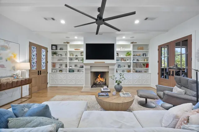 a kitchen with a sink and a stove with wooden floor