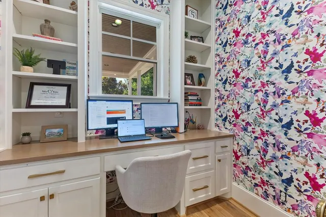 a view of a kitchen area with furniture and wooden floor