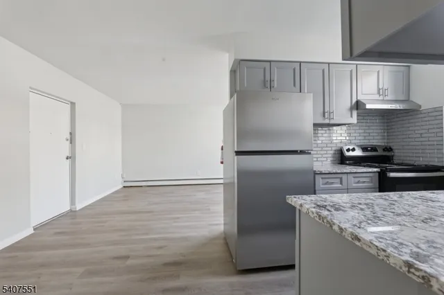 a stove top oven sitting inside of a kitchen