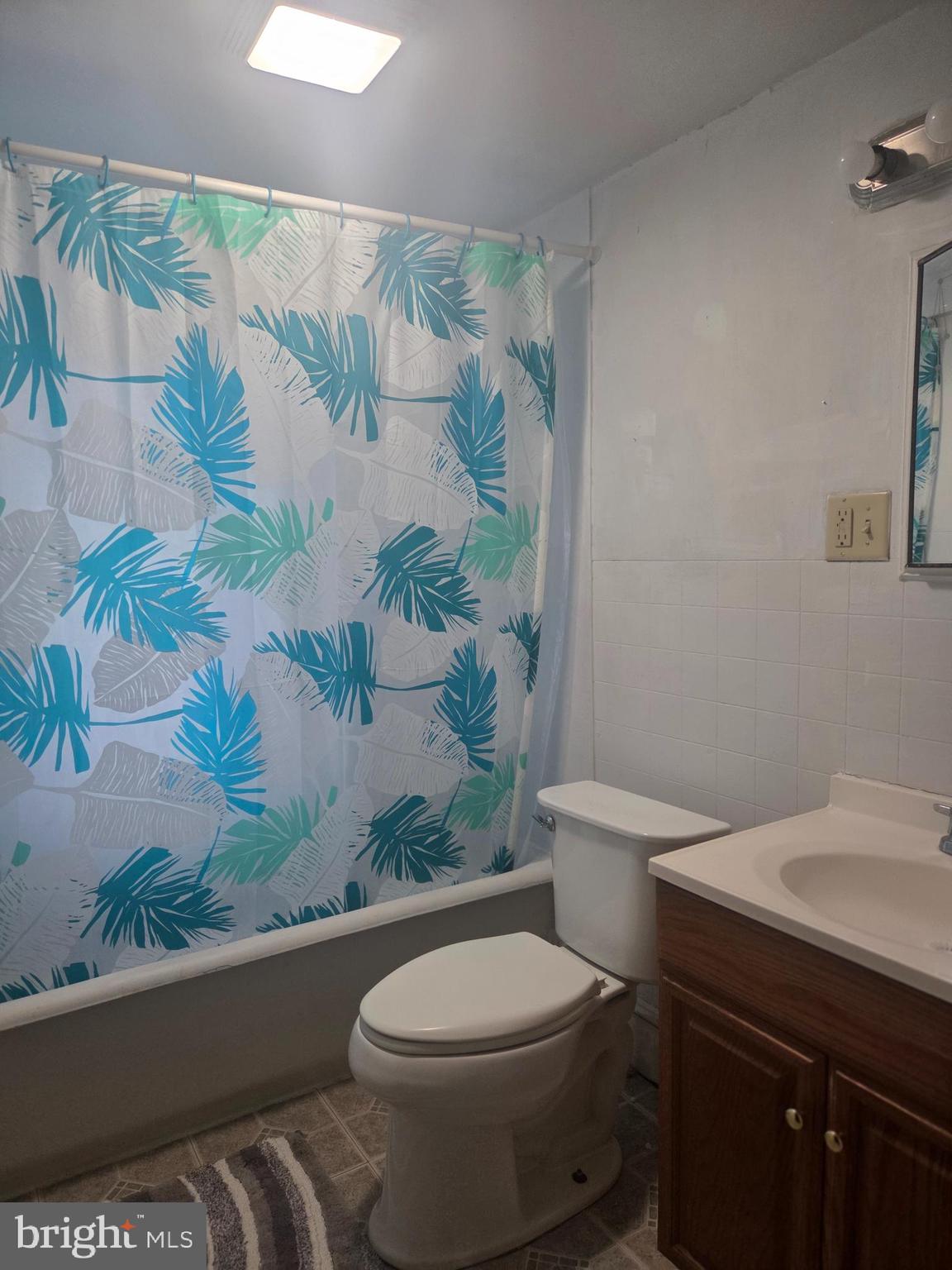 3259 Main Street Conestoga, PA 17516 - Photo 11 of 11 a white toilet sitting next to a shower curtain