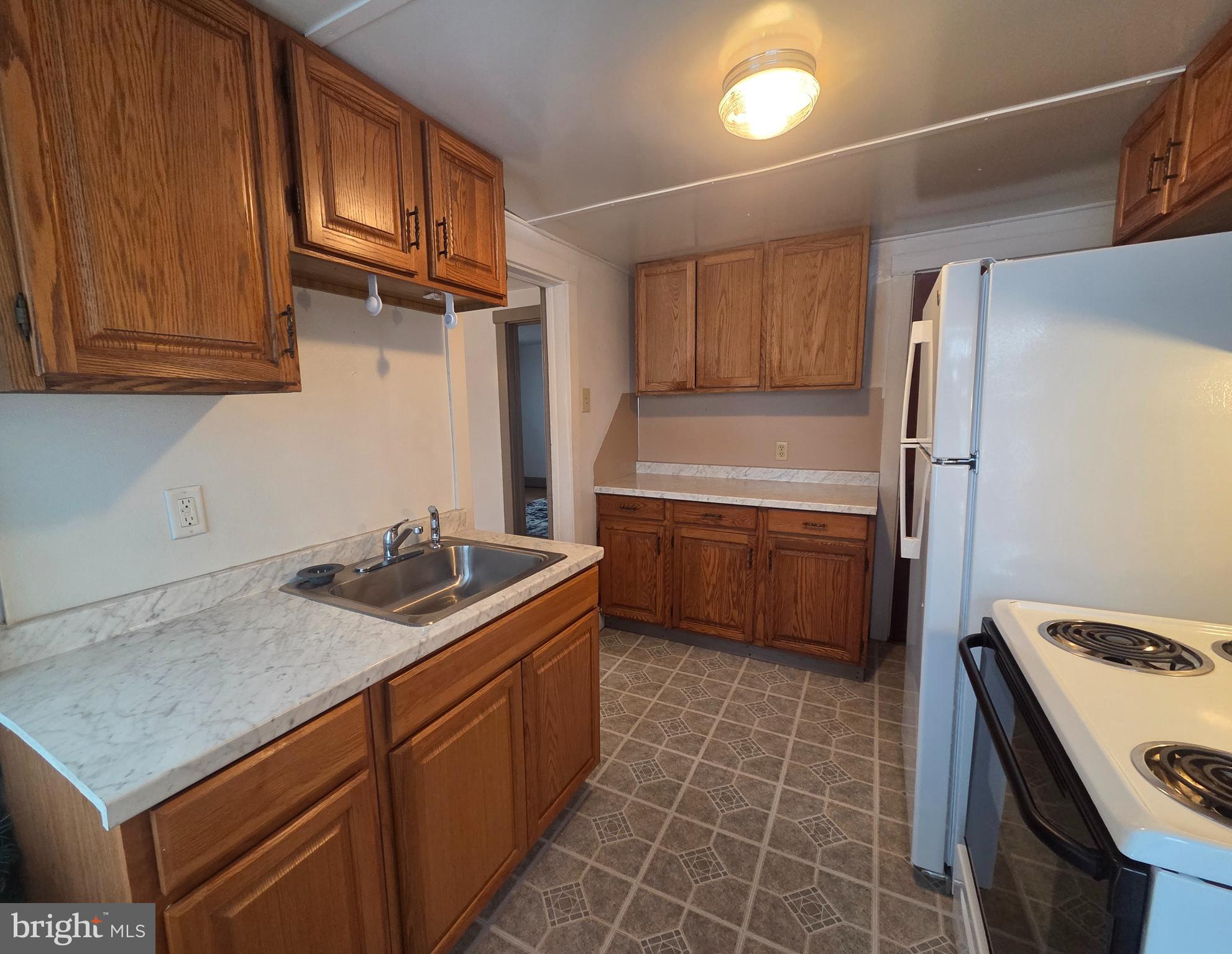 3259 Main Street Conestoga, PA 17516 - Photo 4 of 11 a kitchen with a stove a sink and a refrigerator