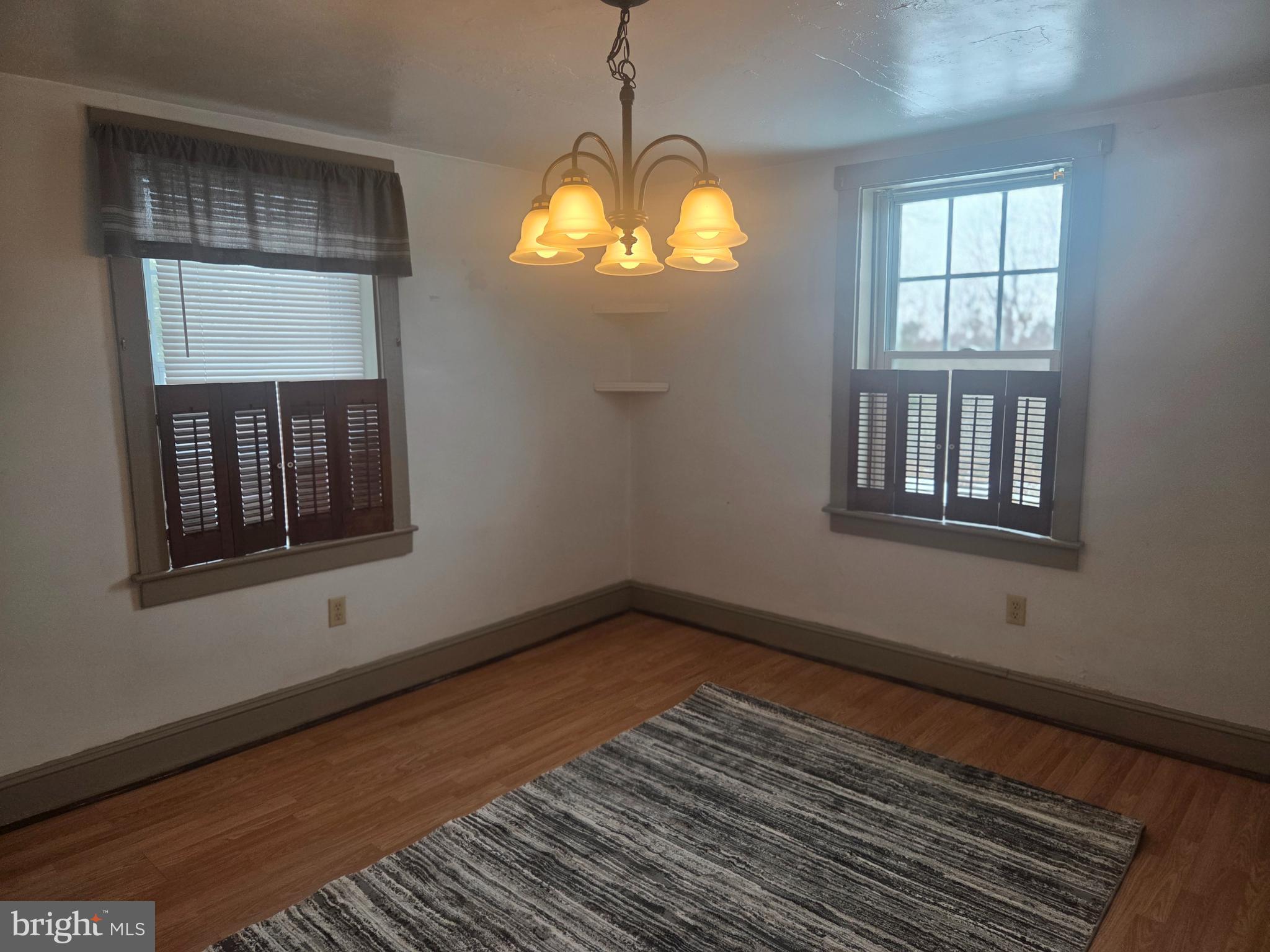 3259 Main Street Conestoga, PA 17516 - Photo 6 of 11 a view of an empty room with wooden floor and a window