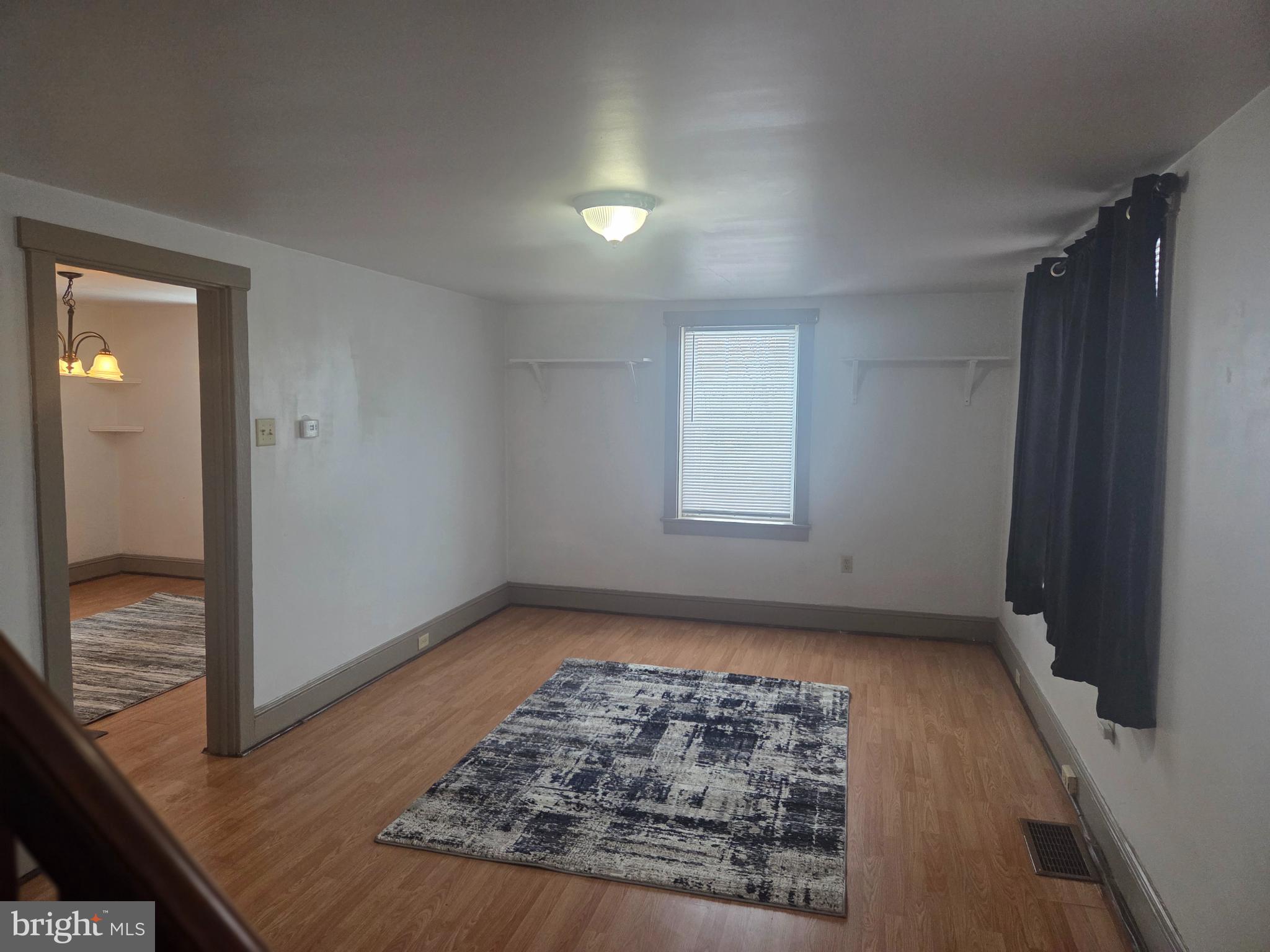 3259 Main Street Conestoga, PA 17516 - Photo 7 of 11 an empty room with wooden floor and windows