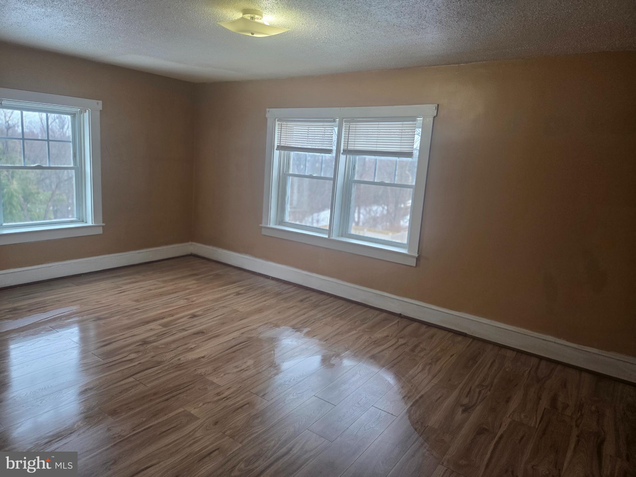 3259 Main Street Conestoga, PA 17516 - Photo 9 of 11 an empty room with wooden floor and windows