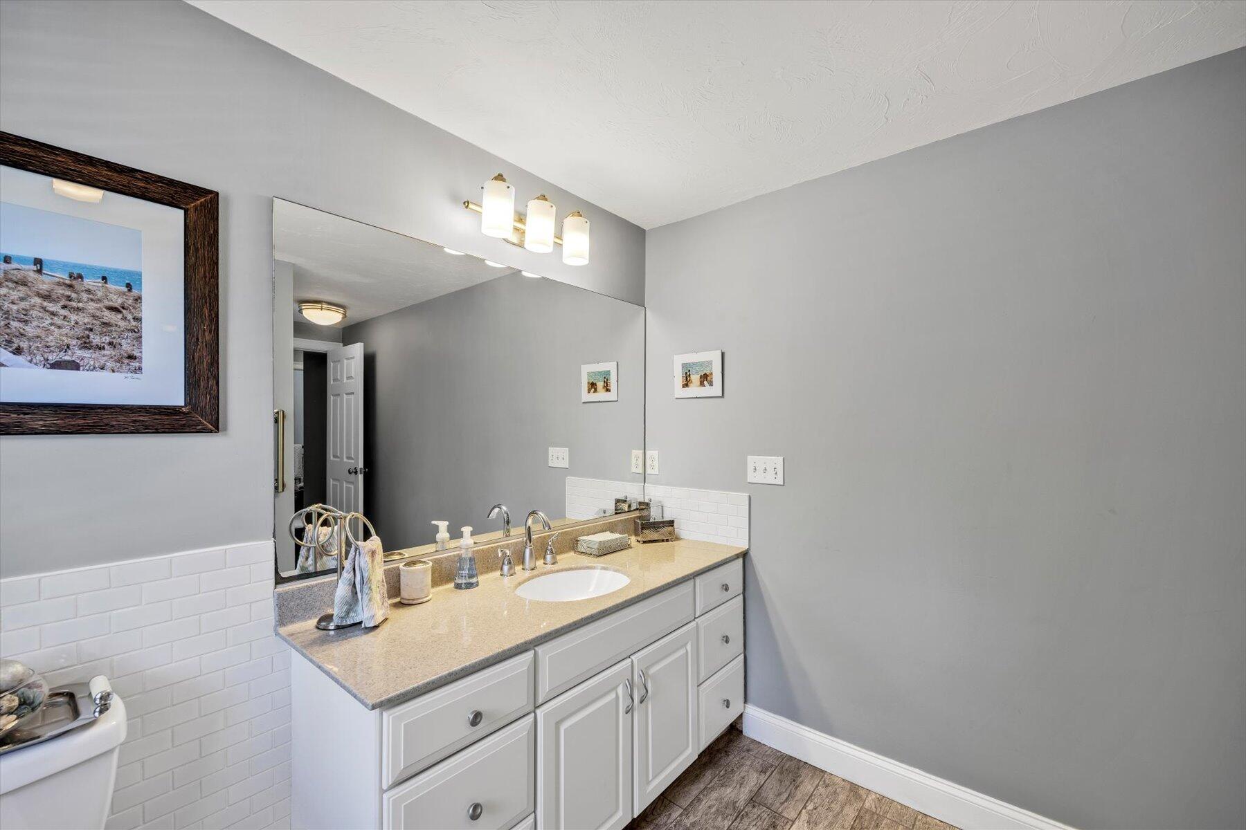 1 Ravens Nest Road Sandwich, MA 02563 - Photo 26 of 46 a bathroom with a sink a vanity and a mirror