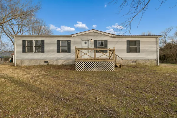 a view of a house with a backyard