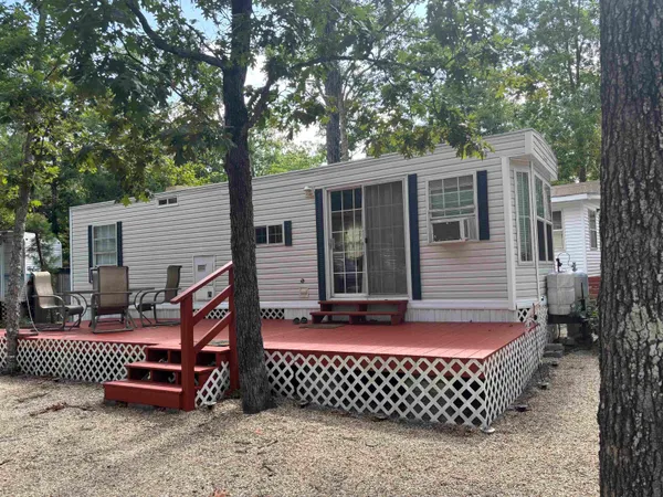 a front view of a house with a tree