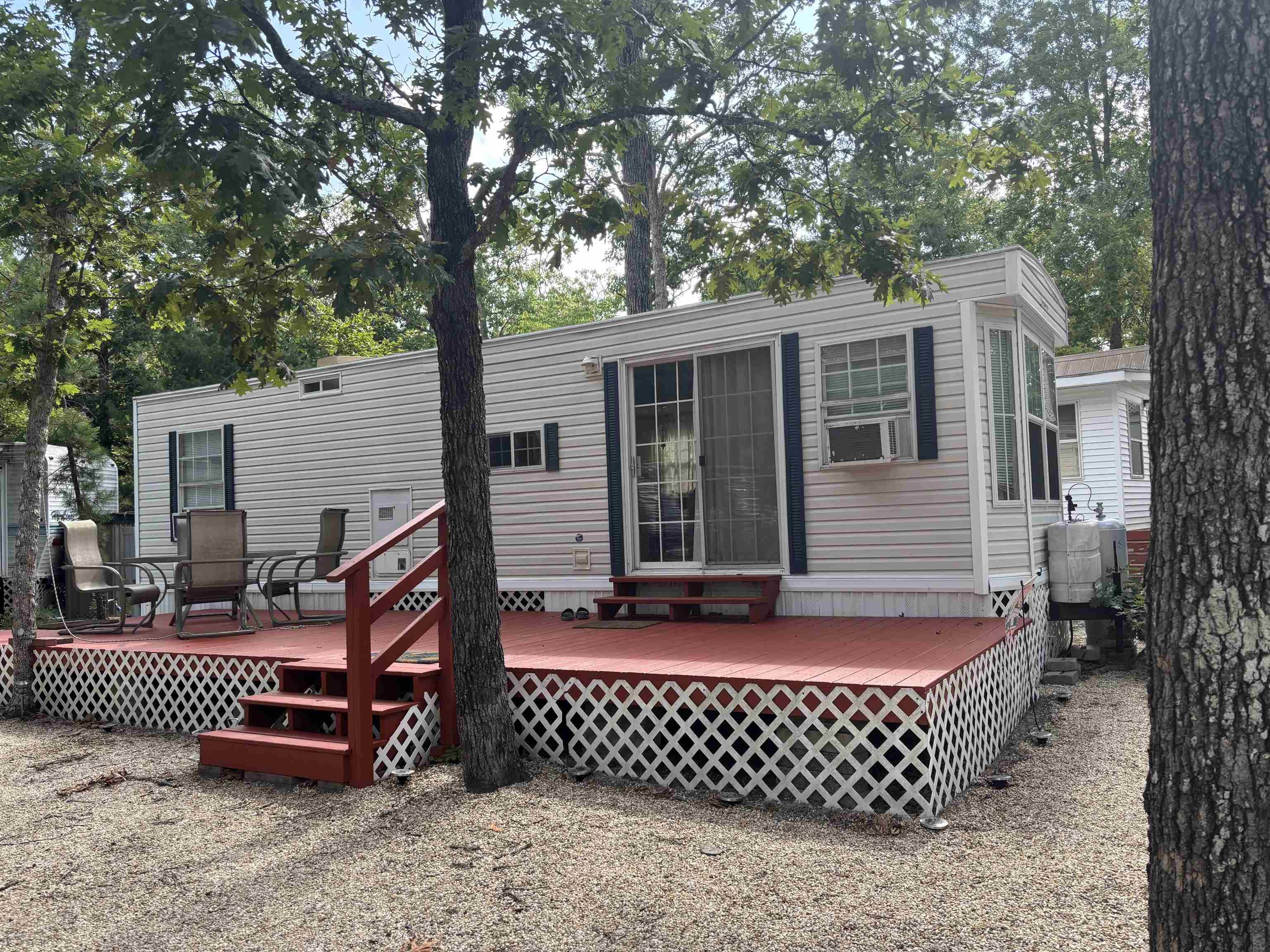 a front view of a house with a tree