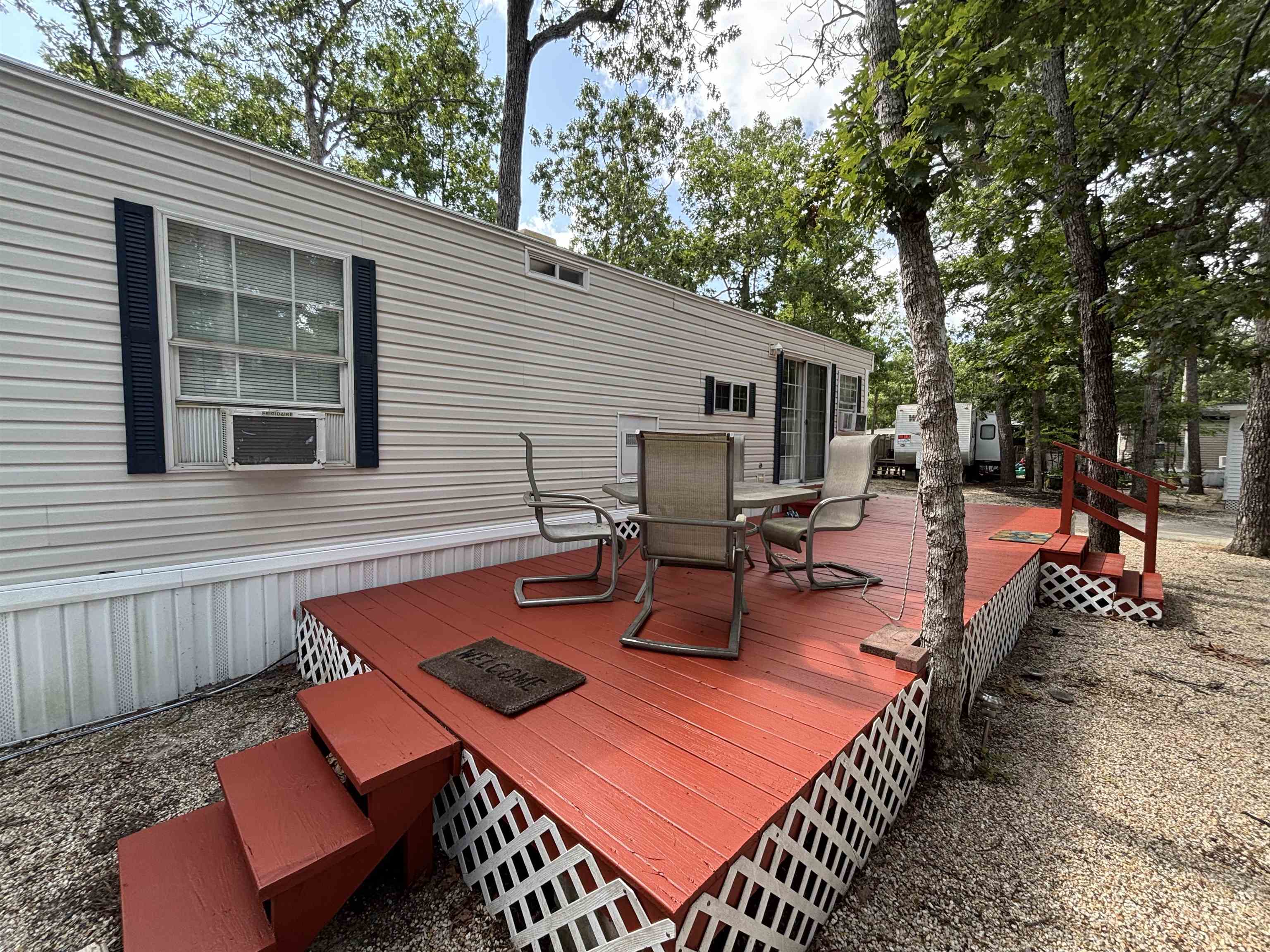 60 Corsons Tavern Road Ocean View, NJ 08230 - Photo 2 of 17 a view of a patio with table and chairs and wooden fence