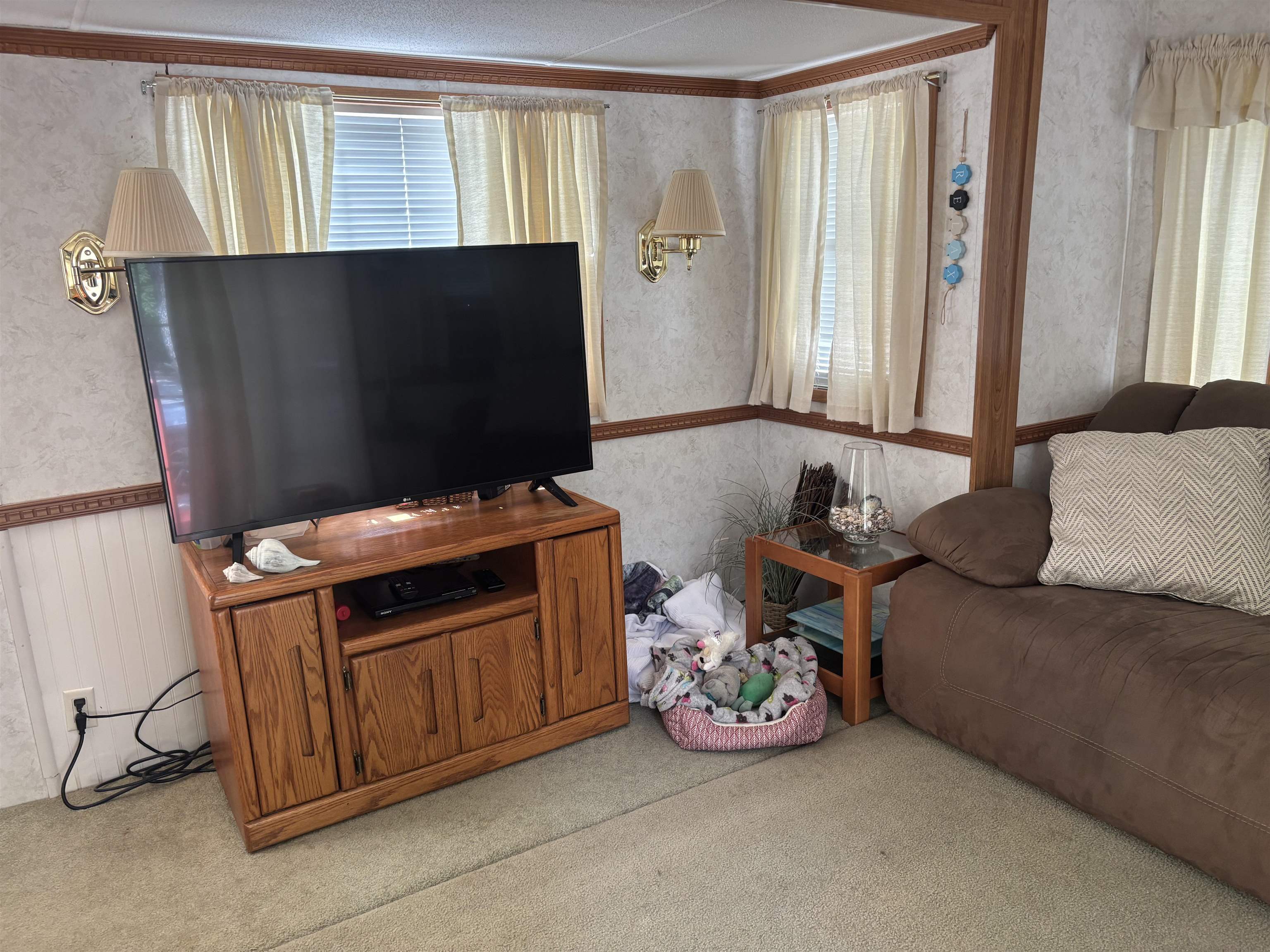 60 Corsons Tavern Road Ocean View, NJ 08230 - Photo 9 of 17 a living room with a couch and a flat screen tv