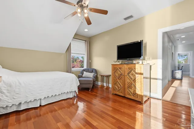 a view of a kitchen counter top space with wooden floor and stainless steel appliances