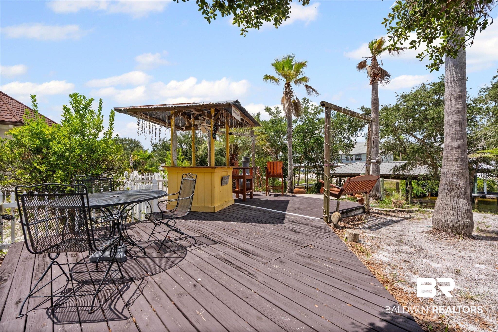 33129 River Road Orange Beach, AL 36561 - Photo 19 of 34 Wooden deck with outdoor dining area