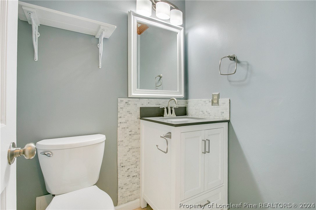 5809 Waldwick Road Fayetteville, NC 28311 - Photo 11 of 33 a bathroom with a granite countertop toilet sink and mirror