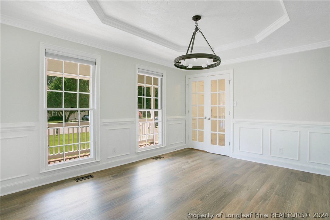 5809 Waldwick Road Fayetteville, NC 28311 - Photo 13 of 33 a view of an empty room with wooden floor and windows
