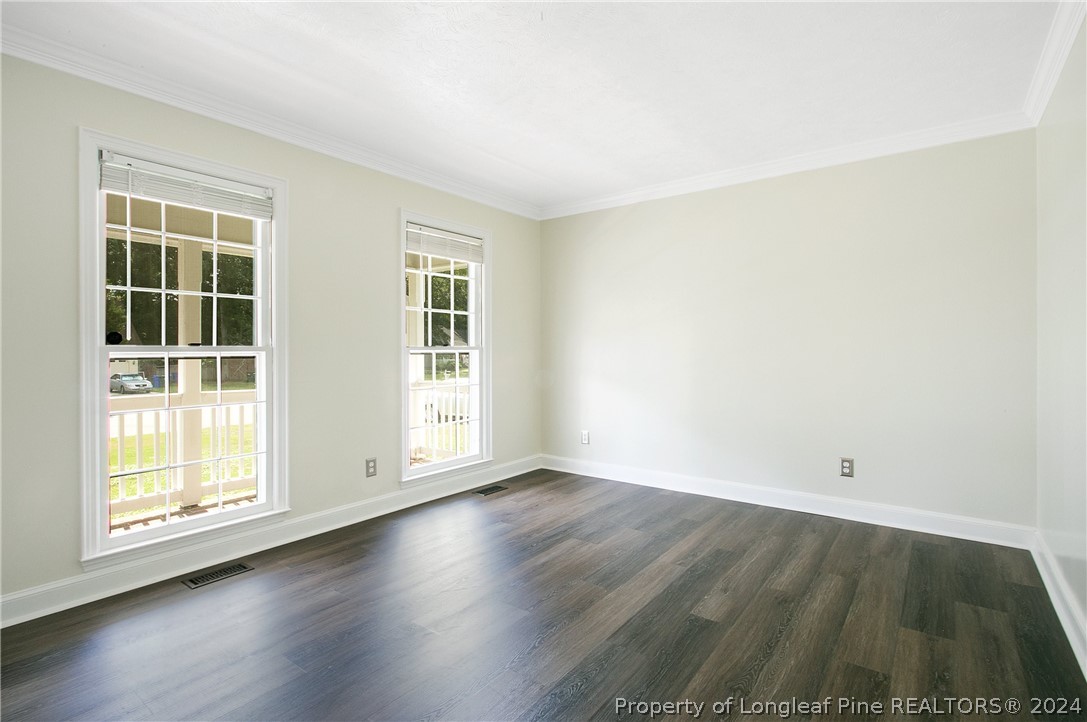 5809 Waldwick Road Fayetteville, NC 28311 - Photo 14 of 33 an empty room with wooden floor and windows