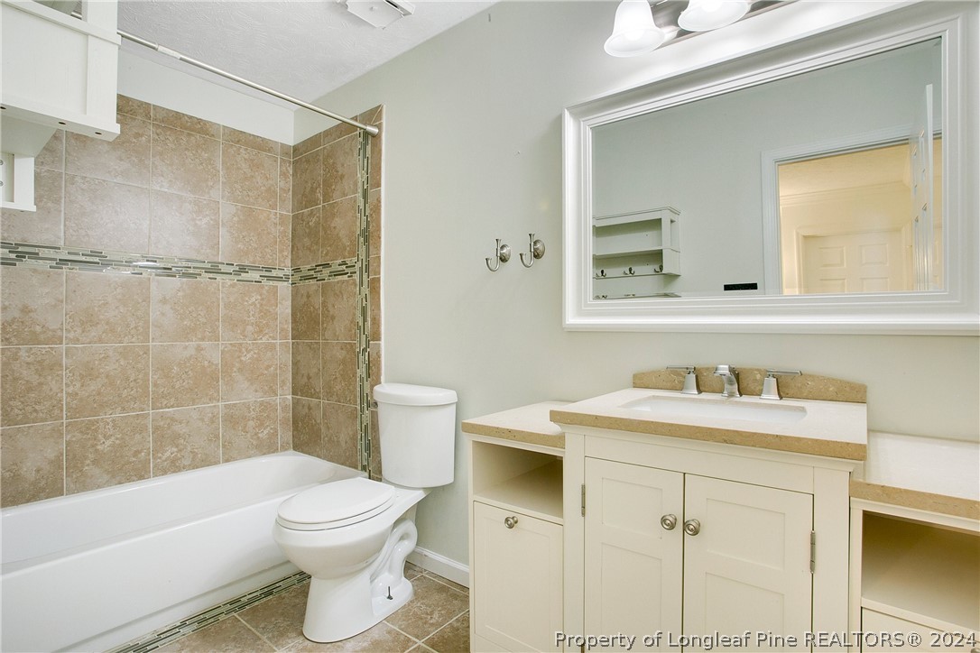 5809 Waldwick Road Fayetteville, NC 28311 - Photo 15 of 33 a bathroom with a sink a toilet and shower